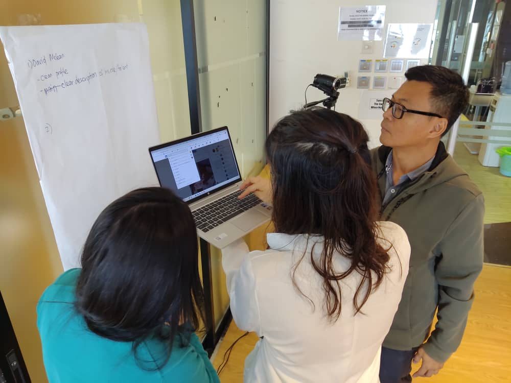 Participants working at a laptop